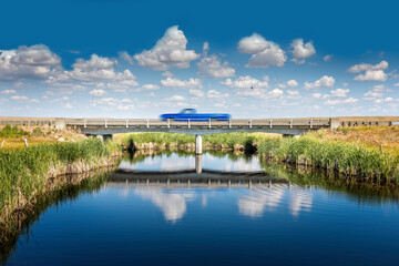 Small bridge on the highway in Montana, a car passing by
