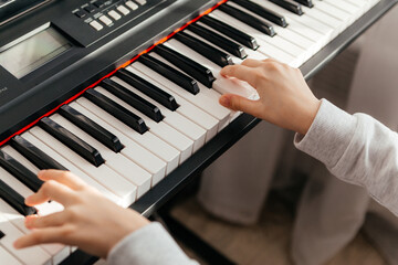 Fototapeta premium Close up hands of caucasian girl playing synthesizer.