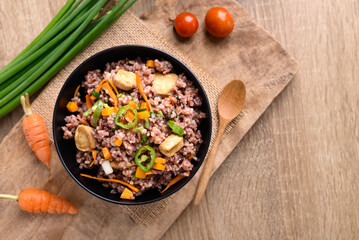 Fried purple rice with tofu, carrot, pumpkin and chili pepper. Healthy Asian vegan food, Table top view