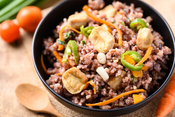 Fried purple rice with tofu, carrot, pumpkin and chili pepper. Healthy Asian vegan food