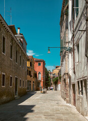 A typical Venetian (Italy) street with tourists in summer