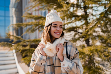 young smiling woman walking in street in winter