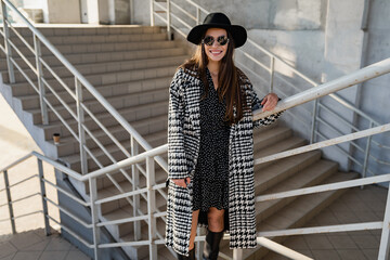 attractive young woman walking in autumn wearing coat