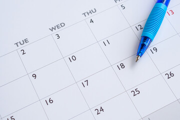 Blue pen on calendar page background business planning appointment meeting concept