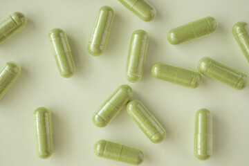 Herbal medicine capsules on white background