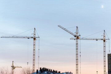 Construction cranes buildings under construction. Copy space