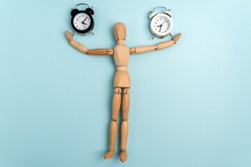 Time and wooden mannequin alarm clock. A matter of time. Space for copying text