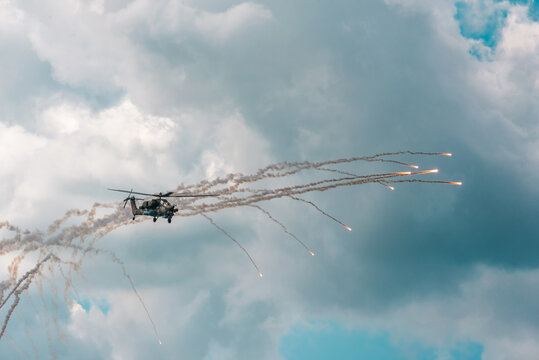 Russian Military attack helicopter shooting flares at the MACS air show in Moscow in a demonstration of Russian air power