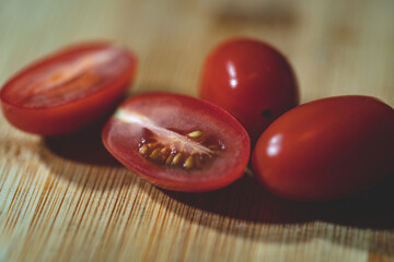 cutted and whole cherry tomato on cutting board