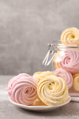 Delicious pink and yellow marshmallows on grey table