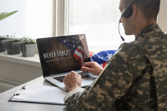military man using laptop with veterans day screen