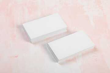 Blank business cards. Mock up on pink marble background. Copy space for text.
