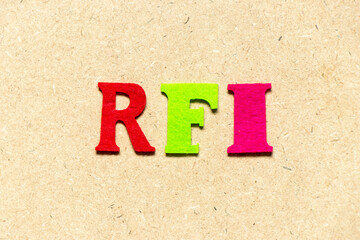 Color cloth alphabet letter in word RFI (Abbreviation of request for information) on wood background