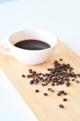 Fototapeta na wymiar Black coffee in a white mug, Coffee beans