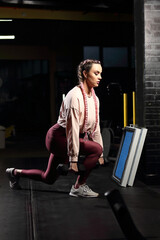 Fototapeta na wymiar Woman in sportswear exercising in the gym