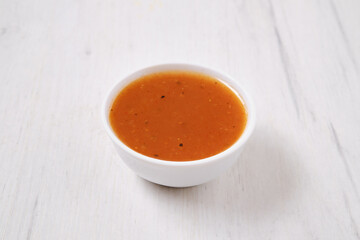 Small bowl with spicy orange sauce