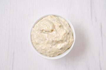 Top view of small bowl with caesar sauce - obrazy, fototapety, plakaty