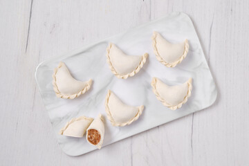 Top view of frozen dumplings stuffed with beef meat and provencal herbs