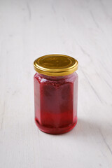 Whole closed jar of cherry jam