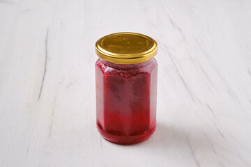 Whole closed jar of cherry jam