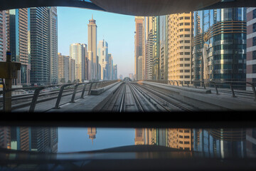 Metro System. View from window of subway car in Dubai in evening rays of sunset. Underground...