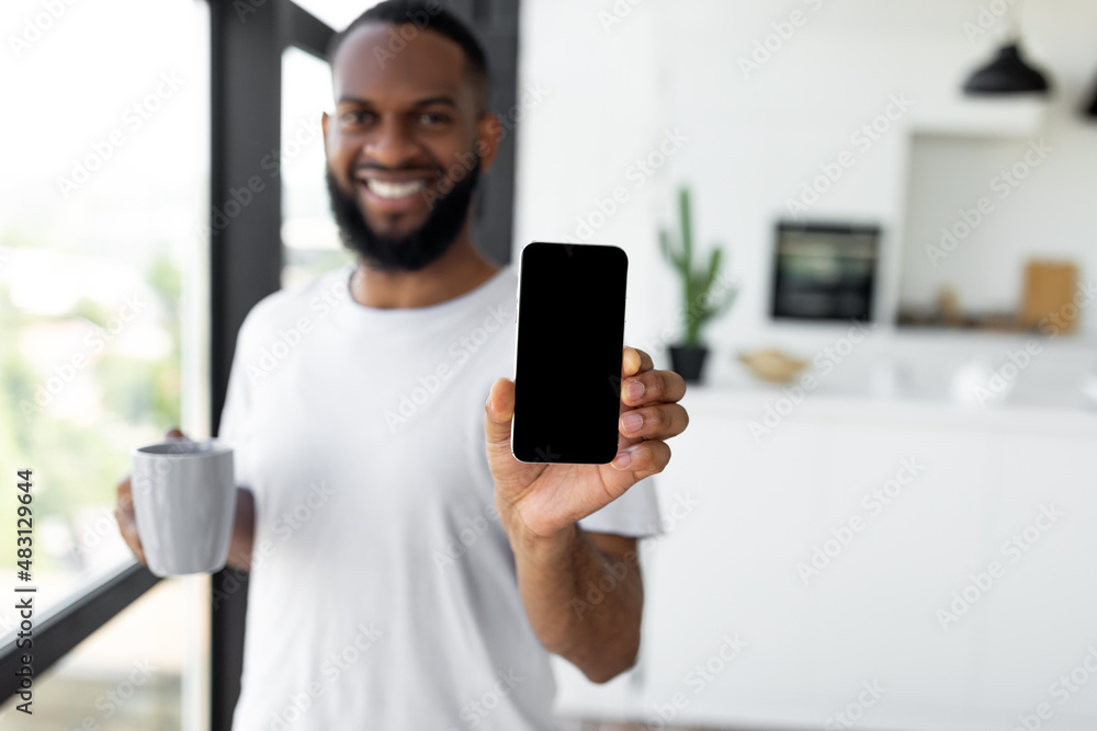 Aufkleber man showing white empty smartphone screen close to camera