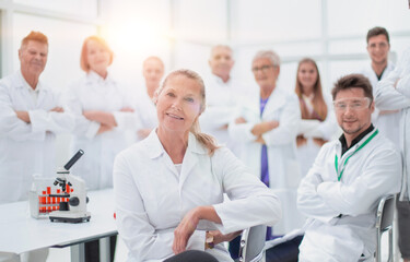 Fototapeta premium research supervisor and a group of young scientists in the workplace .
