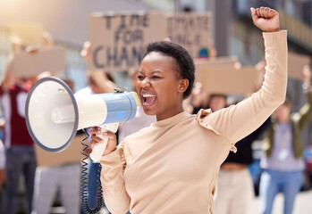 You'll never stop us. Shot of a young woman shouting through a loudhailer at a protest. - obrazy, fototapety, plakaty