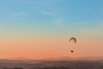 Pico do Gavião, Andradas, Minas Gerais, Brazil: sunset at the top of mantiqueira mountain with paraglaider flight