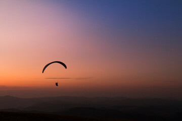 Pico do Gavião, Andradas, Minas Gerais, Brazil: sunset at the top of mantiqueira mountain with paraglaider flight