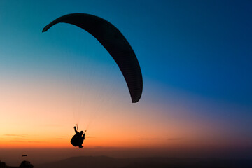 Pico do Gavi&atilde;o, Andradas, Minas Gerais, Brazil: sunset at the top of mantiqueira mountain with paraglaider flight