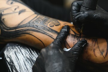 Fototapeta na wymiar Professional tattoo artist working in his tattoo studio.