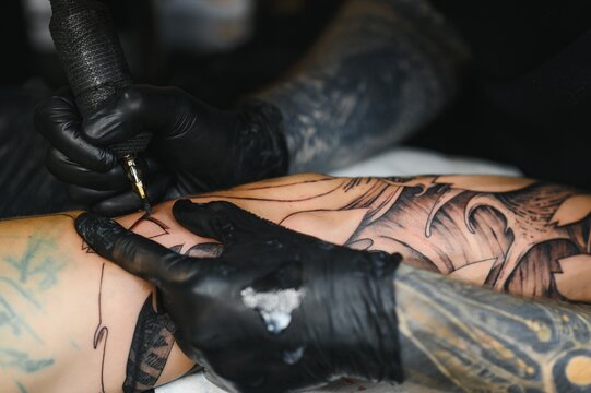 Professional Tattoo Artist Working In His Tattoo Studio.