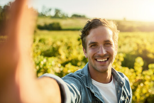 Time to get my harvest on. Shot of a young man taking a selfie while working on a farm. - Powered by Adobe