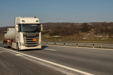 Fuel truck on the road. Truck transporting fuel on the highway.