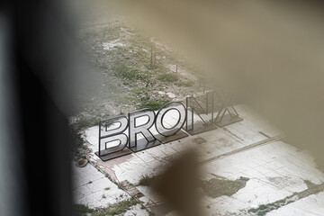 El Bronx sign from broken window of ruin