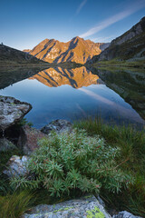 Quiet mountain place with the peaks reflected in the Bos lake  water, Adamello Park, Saviore dell'Adamello, Lombardy, Italy.