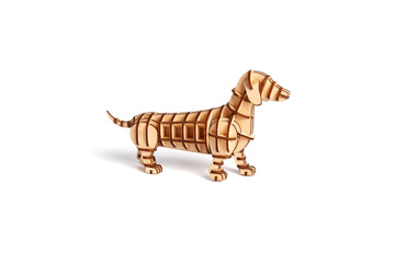 Dog figurine assembled from a wooden puzzle maked by laser processing. Toy dachshund statuette...