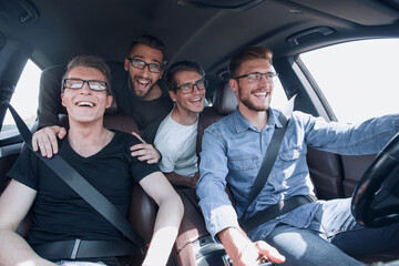 close up. a group of friends traveling in a car - obrazy, fototapety, plakaty