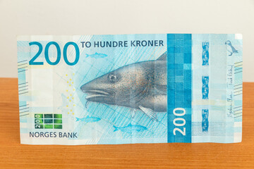 Observe side of norwegian 200 kroner banknote. Banknote with codfish.
