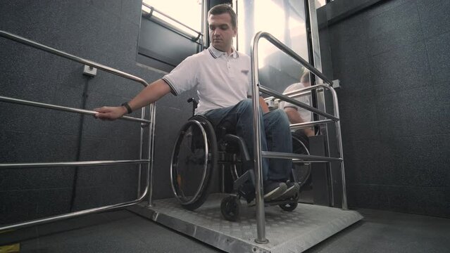 Special elevator for the person with a physical disabilities. A man in a wheelchair uses a special elevator