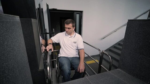 Special elevator for the person with a physical disabilities. A man in a wheelchair uses a special elevator