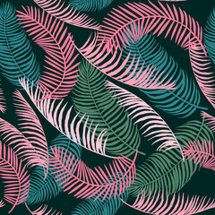 pattern of tropical leaves on a dark background in shades of green and coral