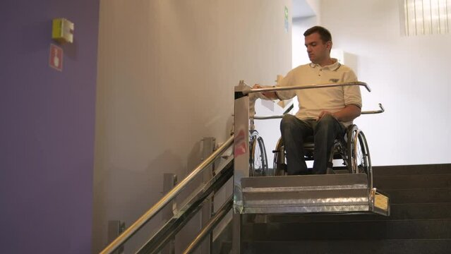 Special elevator for the person with a physical disabilities. A man in a wheelchair uses a special elevator
