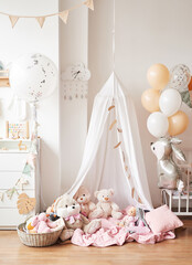 Scandinavian style white interior children's room, bedroom, nursery. Baby cot with canopy. Wooden shelves and toys. Canopy tent, textile kite and balloons
