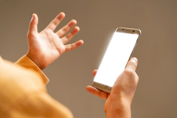 Cropped shot view of man hands holding smart phone with blank copy space screen