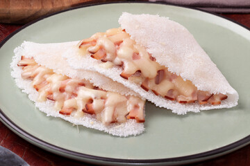 Focus on Brazilian tapioca stuffed with turkey breast and cheese. .