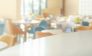 Space of desk over blur cafe background. Empty table and blurred bokeh cafe light background.