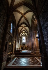 Fototapeta na wymiar St Magnus Cathedral, Orkney, Scotland - Soaring, multi-hued sandstone originally founded by the Vikings, Britain's most northerly cathedral- Interior Shot