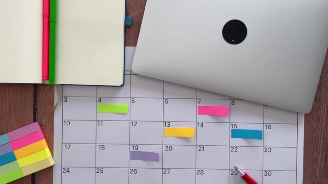 View from above several colored adhesive note to highlight the activities to be carried out in the next months of the year. Concept of achievement of objectives and goals. High quality photo